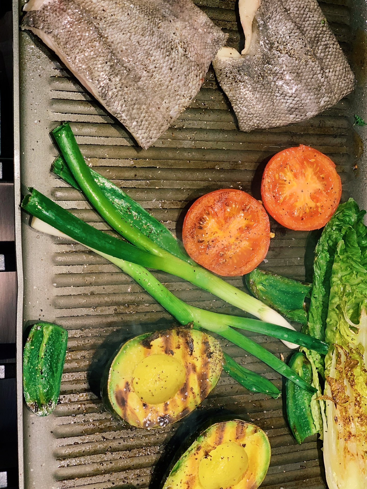 Veggies on grill pan with fish
