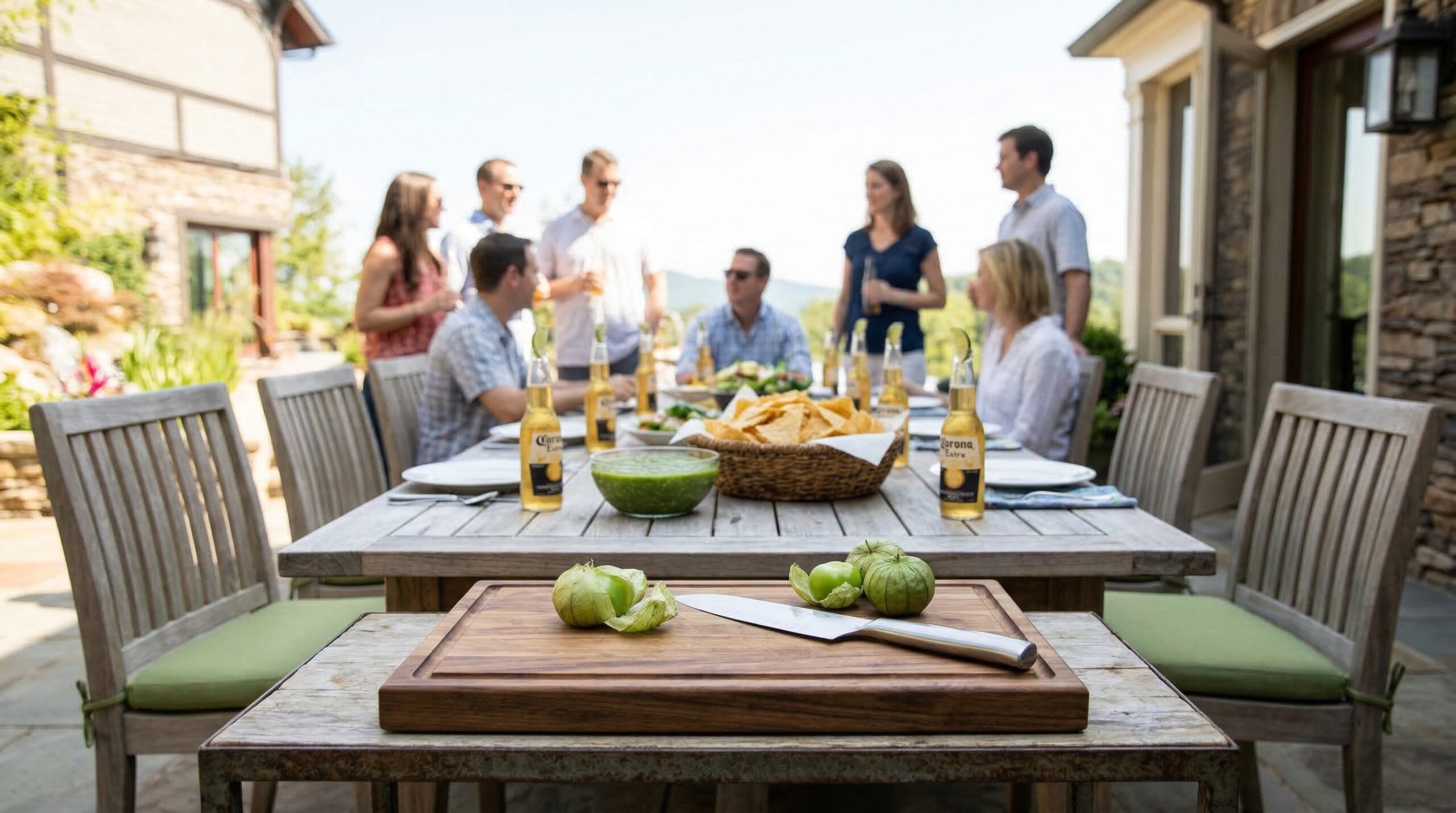 Abundant emerald green salsa and tortilla chip service for eight on a sun-drenched estate patio